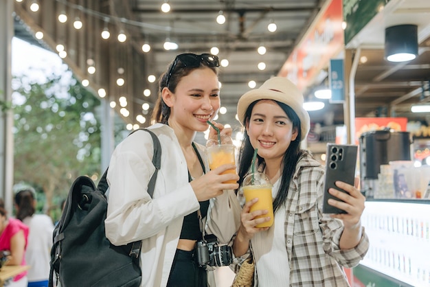 two women are holding drinks and one of them is holding a glass