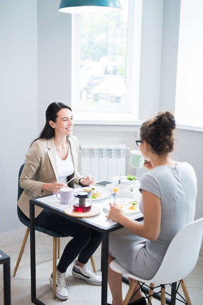 Two Women Enjoying Time in Cafe