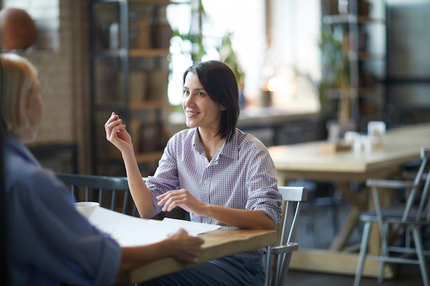 Two Women Enjoying Work Meeting in Cafe