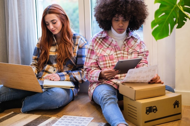 Two women entrepreneurs making packages to send their business orders to their customers Concept business small business teamwork