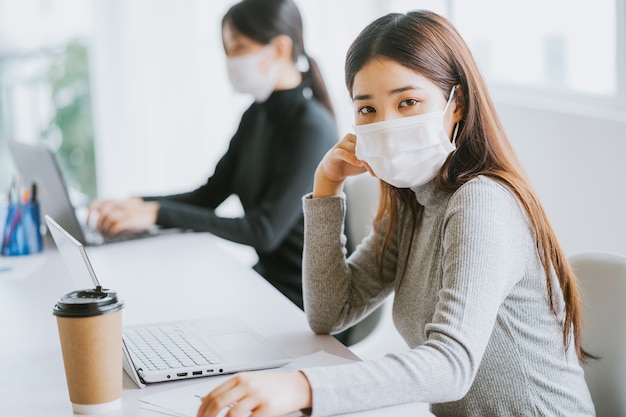 Two women have to wear masks during working hours to stay safe during epidemics