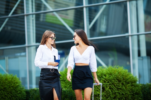 Two women near the airport go on a plane