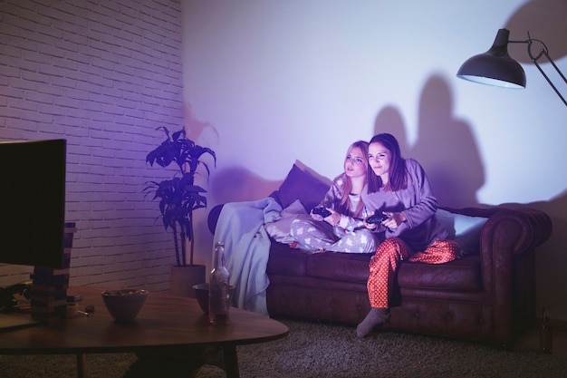 Two women playing on console