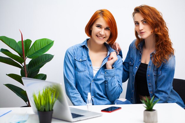 Two women work together as a team in the company office