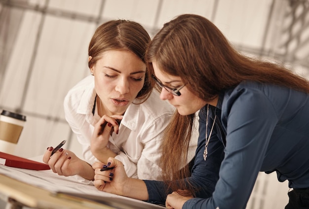 Two women working together at an architect s office.