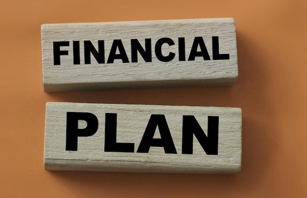 Two wooden blocks with the inscription financial plan lon red Business concept