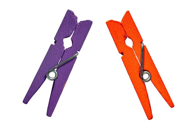 Two wooden clips purple and orange on an isolated white background