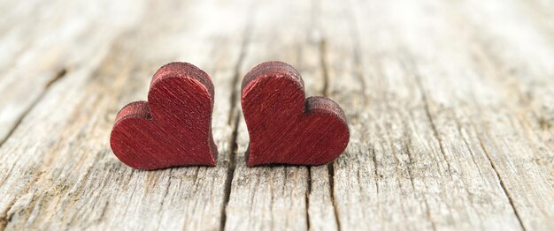 Two wooden hearts on rustic table