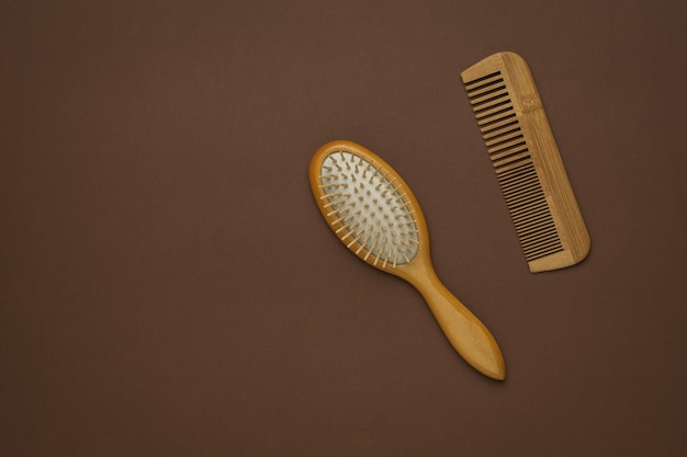 Two wooden vintage combs on a brown background.