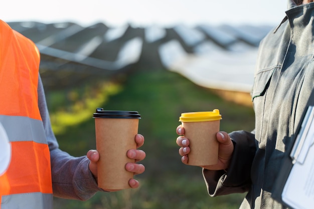 Two workers in uniform with coffee at the break