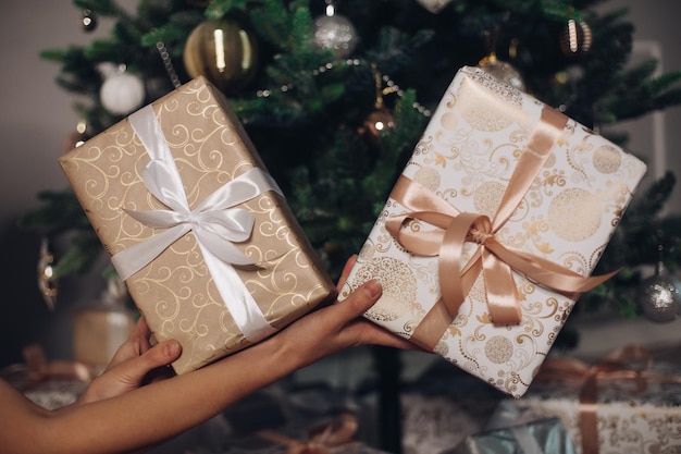 Two wrapped Christmas presents in hands