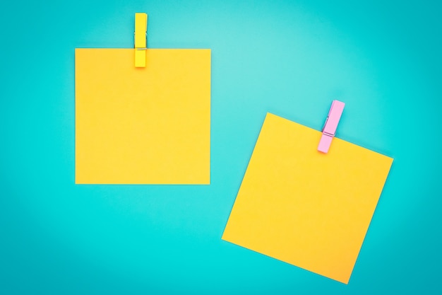 Two yellow stickers on turquoise background. Planning concept.