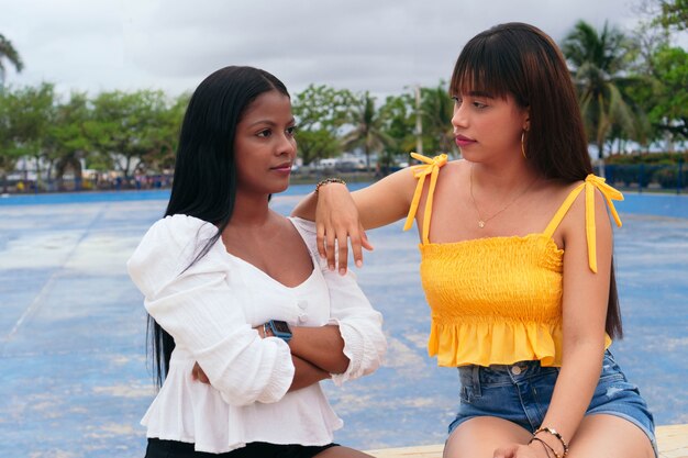 Two young adults sitting outdoors