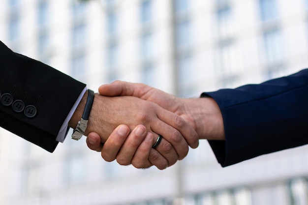 Two young business people shaking hands