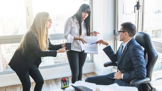 Two young businesswoman at his businessman's service in the office