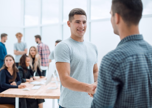 Two young employees discussing a business document