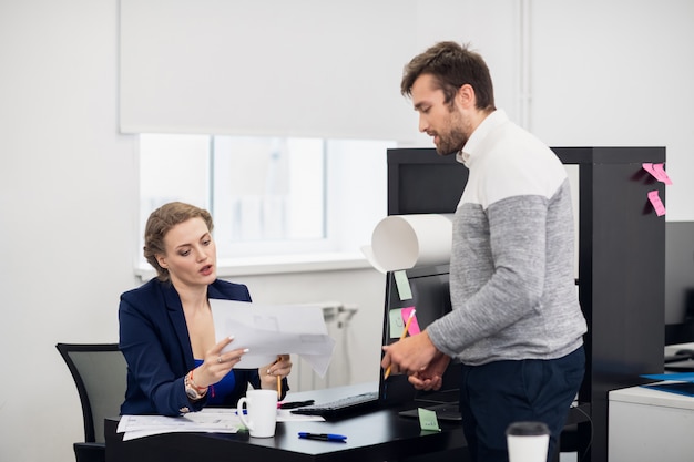 Two young employees working in the office