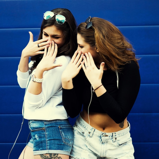 Two young hipster girl friends together having fun Outdoors lifestyle