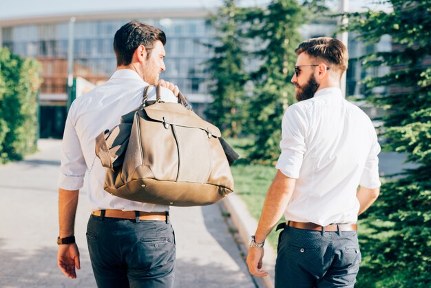 two Young modern businessman posing