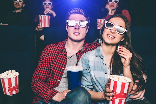 Two young people are sitting close to each other