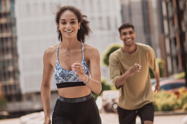 Two young people running and smiling