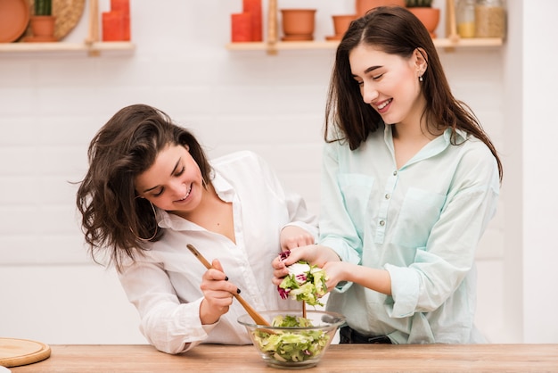 Two young women cooking in the kitchen