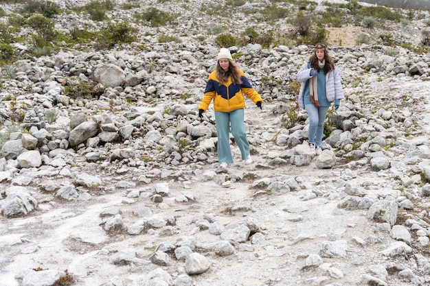 Two young women walking in the snow at he mountain