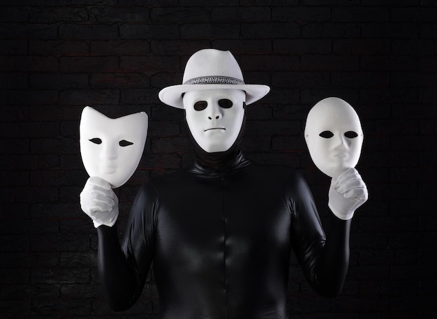 Photo twofaced man in a white mask on a black background