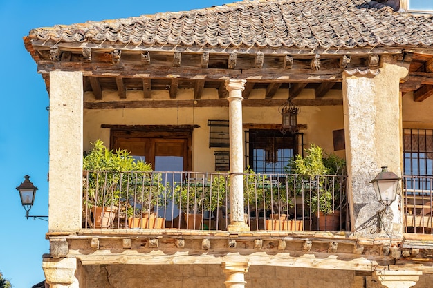 Typical balcony of the medieval town of stonework in stone building with wooden roof and tile Pedraza Spain