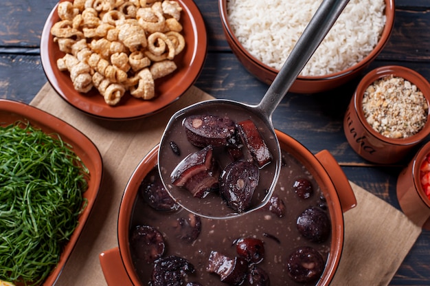 Typical Brazilian dish called Feijoada. Made with black beans, pork and sausage. Top view