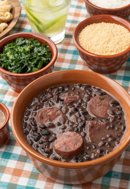 Typical brazilian feijoada with rice caipirinha farofa and cracklings