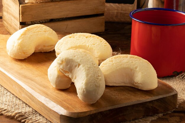 Typical Brazilian snack cheese biscuit on cutting board Selective focus