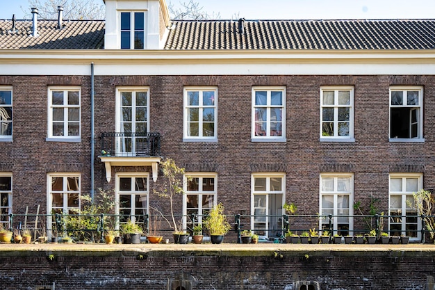 Typical canal houses with the famous Amsterdam posts along the sidewalk