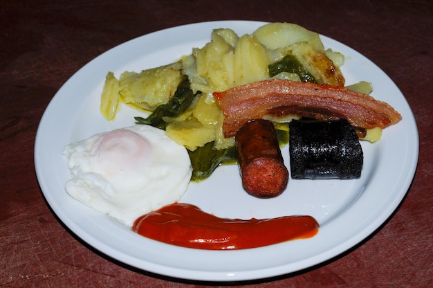 Typical dish from the alpujarra with potatoes chorizo peppers black pudding and fried egg