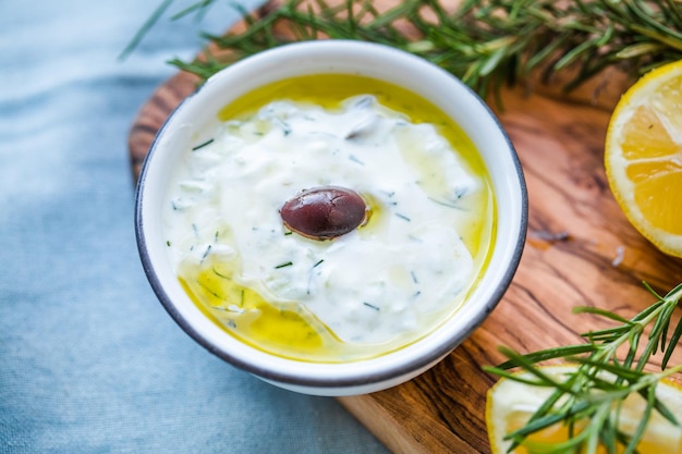 Typical Greek snack consisting of tzatziki sauce with cucumber olives and bread