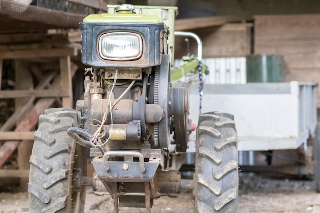 Typical heavy diesel walking tractor with trailer Agricultural transport equipment of the countrysid