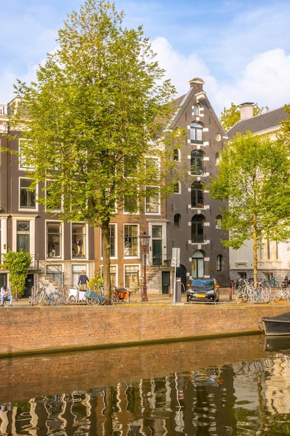 Typical Houses on the Amsterdam Canal and Car and Bicycles