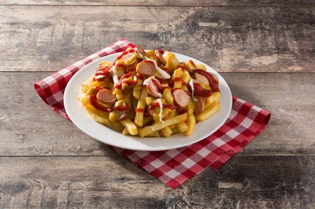 Typical Latin America Salchipapa. Sausages with fries, ketchup,