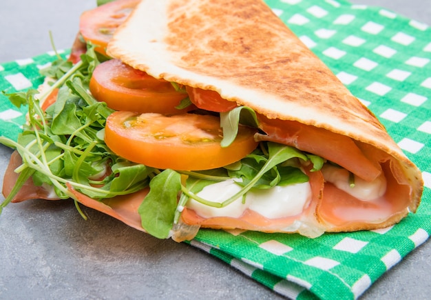 Typical piadina romagnola with ham, cheese and rocket