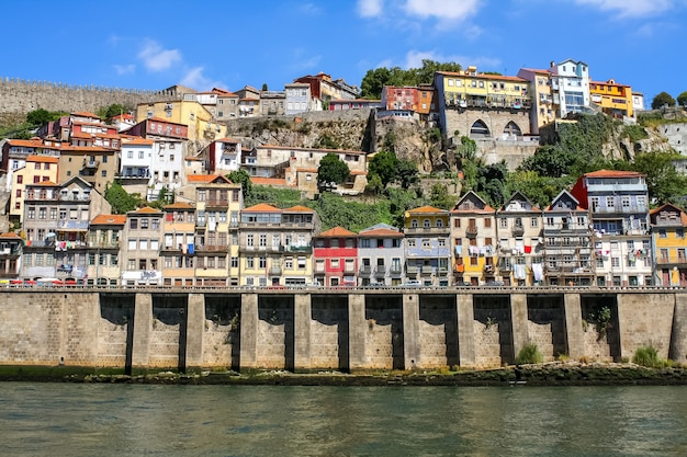 Typical Porto houses next to the Douro River, picturesque architecture of lined houses and bright colors. Portugal. Europe.