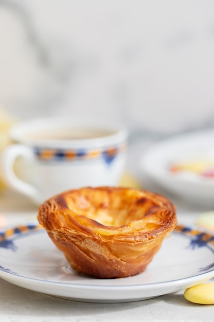 Typical portuguese dessert pastel de nata and cup of coffee