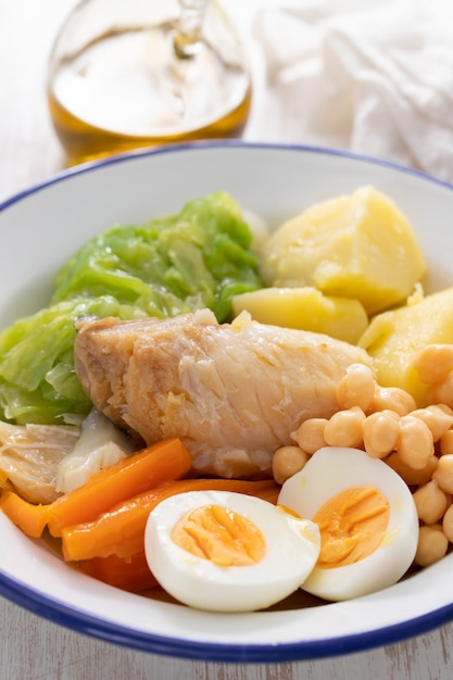 Typical Portuguese dish cod fish with boiled egg and vegetables