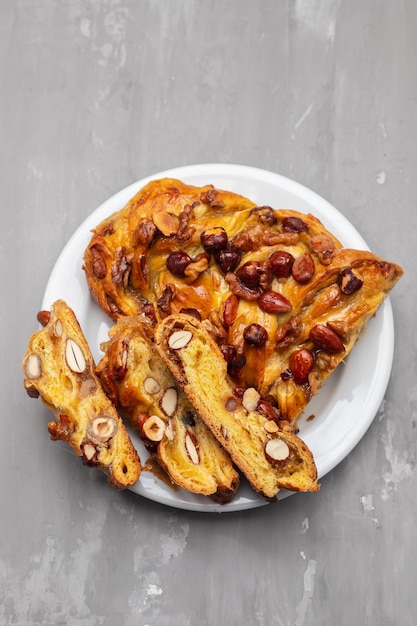 Typical portuguese fruit cake Bolo rainha on white dish