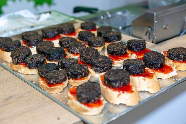 Typical spanish tapas with blood sausage on a slice of bread morcilla