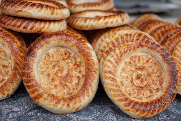 Typical traditional flatbread with crunchy crust with sesam just baked in tandoor on market display