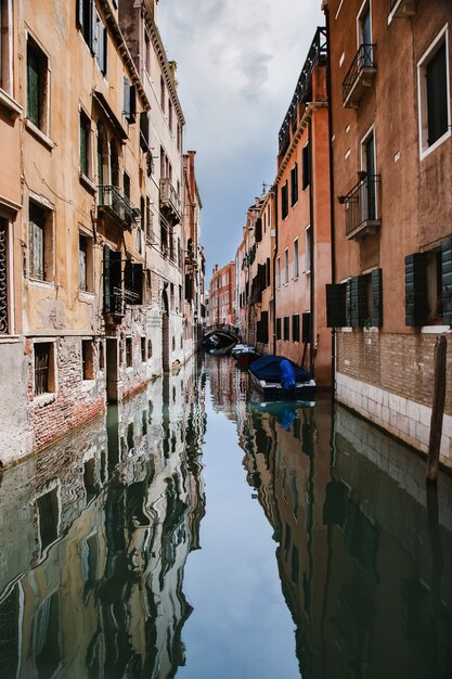 Typical Venice narrow canal with boats. Streets of Venice. Springtime. Italy