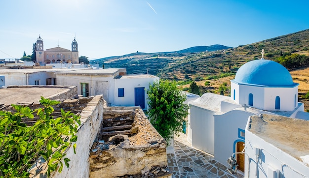 Typical whitewashed church with blue dome on the corner of the street, Lefkes, Paros island, Greece