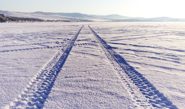 Tyre tracks in the snow on lake Baikal ice surface