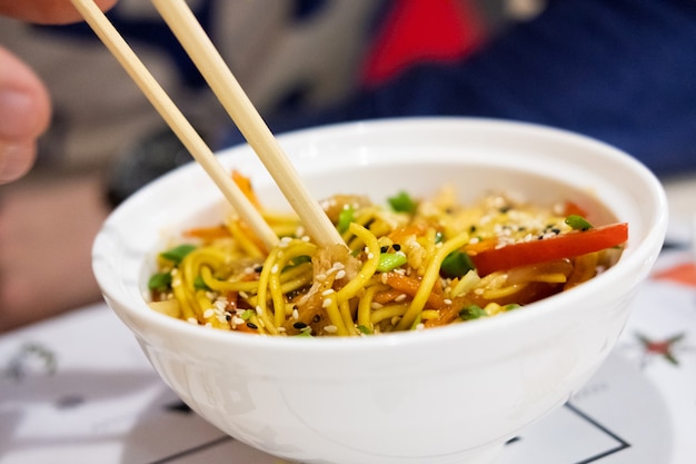 Udon noodles with meat and vegetables in an Asian style