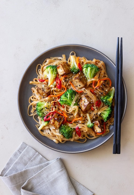 Udon noodles with tofu broccoli carrots pepper and sesame Healthy eating Vegetarian food Asian food